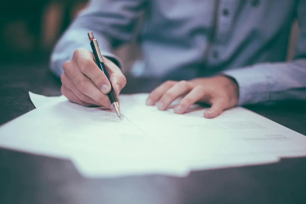 An adviser reviewing and signing documents